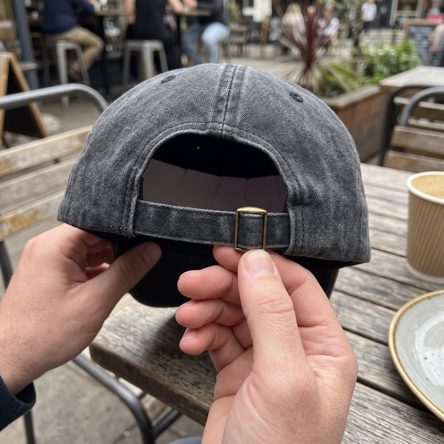 Owner view of the adjustable slider on a Black cap at a café